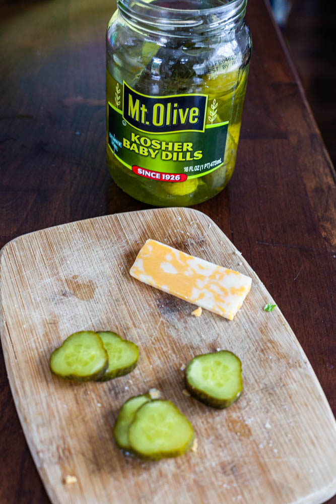 Mt. olive Dill pickles with colby jack cheese on cutting board